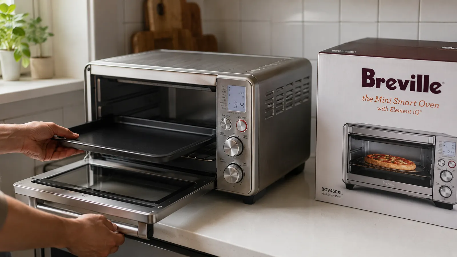 Hand placing a small baking pan into the Breville BOV450XL Mini Smart Oven