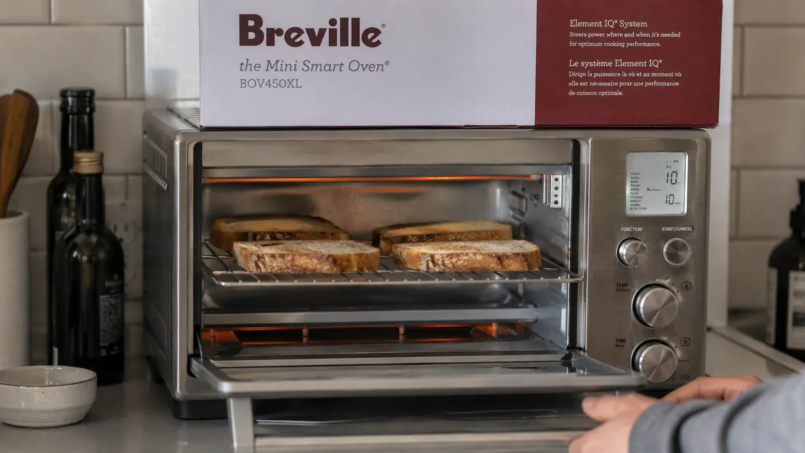 Overhead view of the Breville BOV450XL interior showing the four-slice rack position with two slices of sourdough toasting