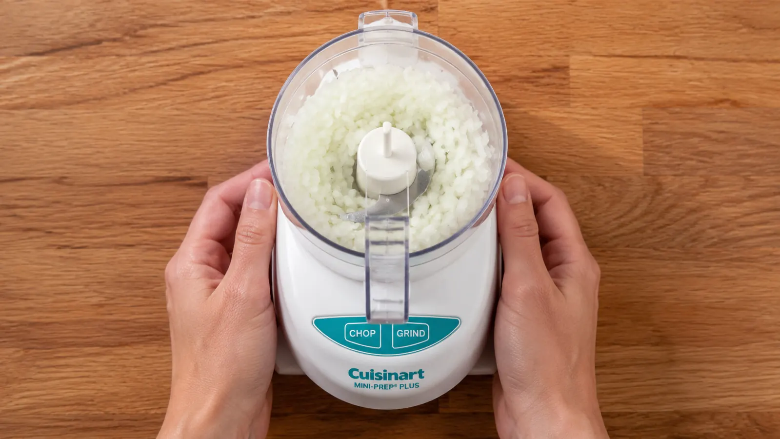 Cuisinart Mini-Prep Plus with lid locked and bowl filled with roughly chopped onion